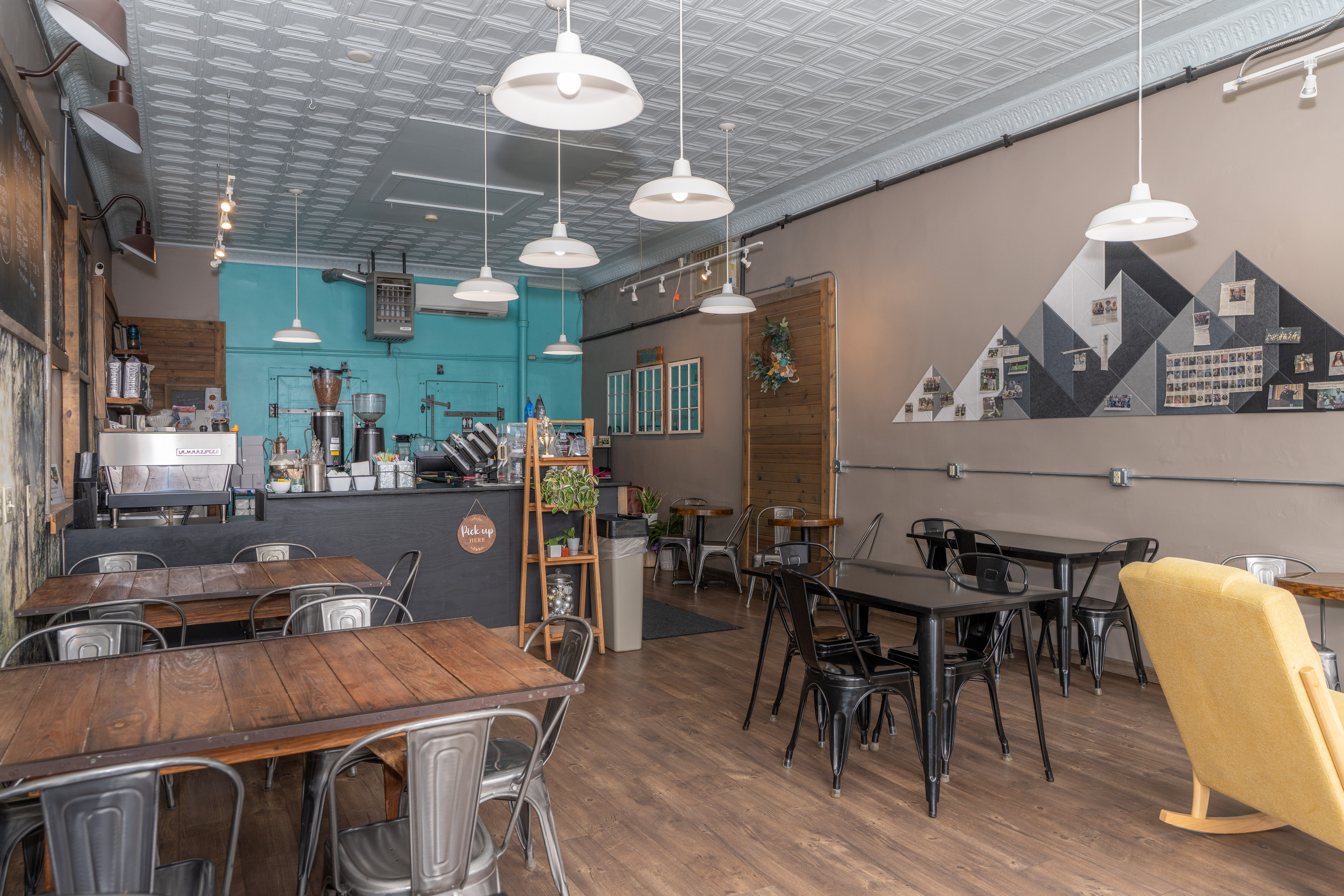 Wide view of the café dining room, service counter, and original commercial interior